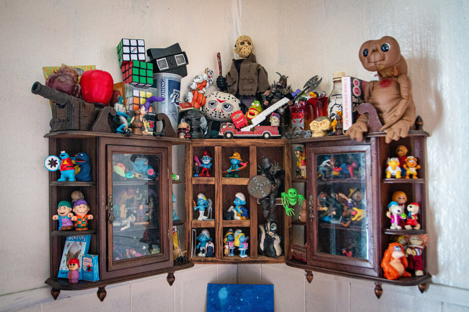 This cabinet is covered in vintage toys and childhood memorabilia, from E.T. to Snoopy and many others.